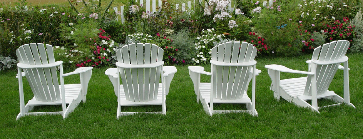 4 white chairs in a garden